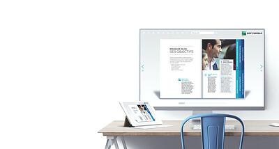 A BNP Paribas Fluidbook displayed on a desktop screen, with a tablet on the desk beside it